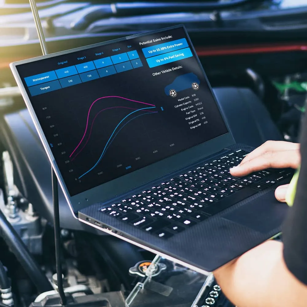ECU remapping software on a laptop showing horsepower and torque gains