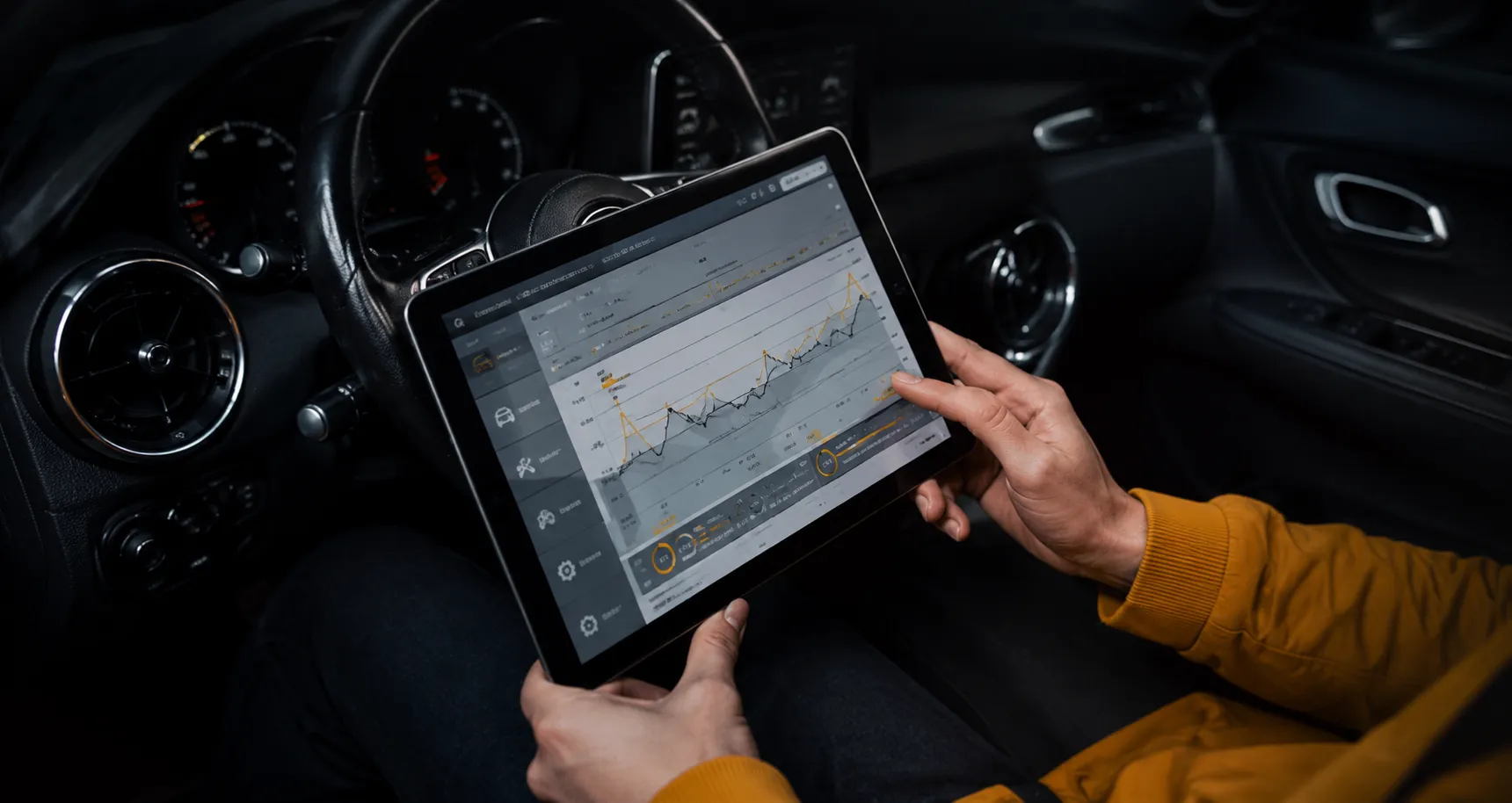 Technician reviewing live vehicle diagnostic data on a tablet inside a car
